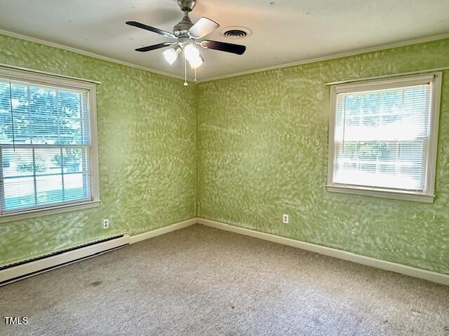 1007 Driftwood Dr, Siler City, NC 27344 - carpeted empty room featuring a baseboard heating unit, ornamental molding, and ceiling fan