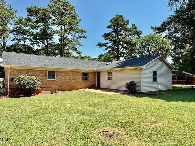 1007 Driftwood Dr, Siler City, NC 27344 - back of property with a yard, a patio area, and roof with shingles