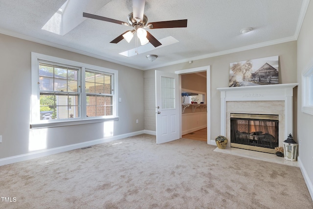 3009 Wellington Dr, Rocky Mount, NC 27803 - unfurnished living room with carpet flooring, a ceiling fan, ornamental molding, a textured ceiling, and a skylight