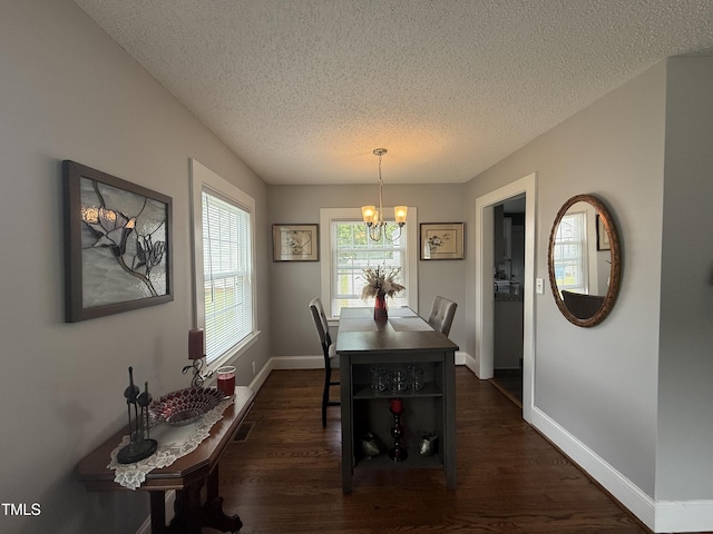 306 W Canary St, Dunn, NC 28334 - dining room featuring a textured ceiling, a chandelier, dark wood-type flooring, and baseboards