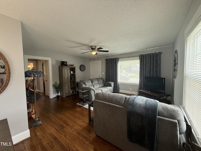 306 W Canary St, Dunn, NC 28334 - living area with dark wood finished floors, baseboards, ceiling fan, and a textured ceiling