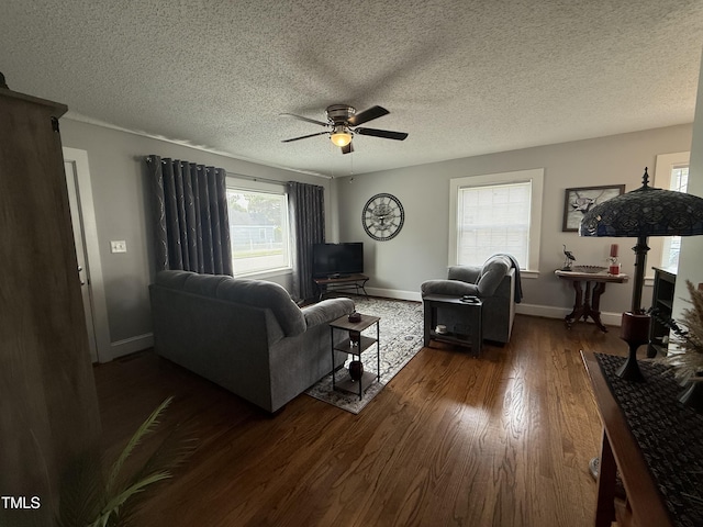 306 W Canary St, Dunn, NC 28334 - living room with dark wood-type flooring, ceiling fan, baseboards, and a textured ceiling