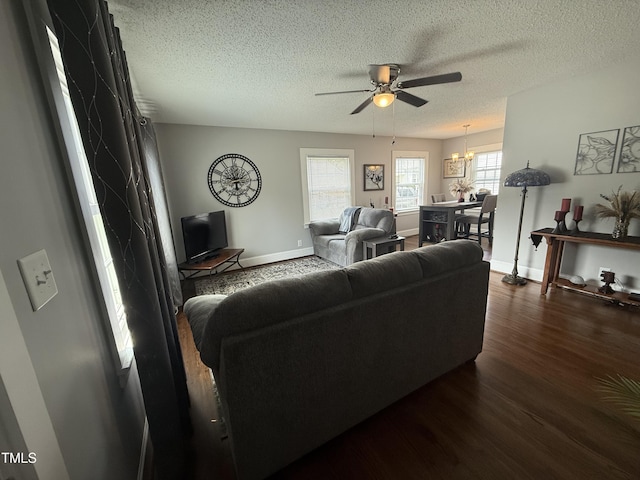 306 W Canary St, Dunn, NC 28334 - living room with ceiling fan, dark wood-style floors, a textured ceiling, baseboards, and a chandelier