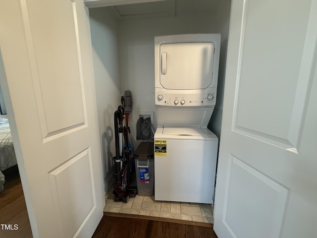 306 W Canary St, Dunn, NC 28334 - laundry room featuring stacked washing machine and dryer and wood finished floors