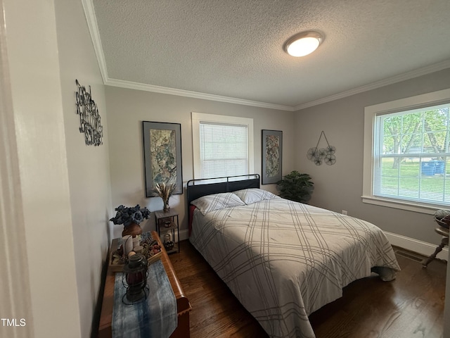 306 W Canary St, Dunn, NC 28334 - bedroom with a textured ceiling, multiple windows, ornamental molding, dark wood-type flooring, and baseboards