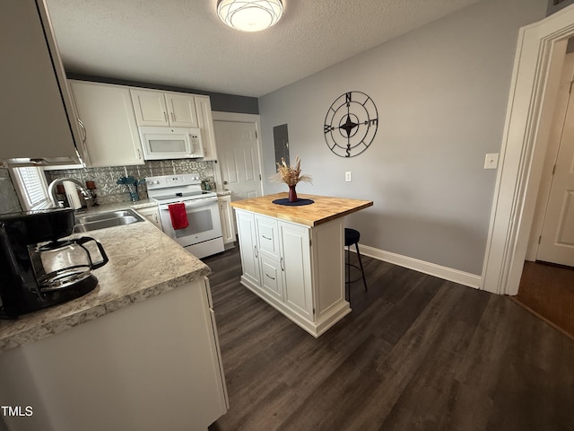 306 W Canary St, Dunn, NC 28334 - kitchen with white appliances, butcher block counters, white cabinetry, dark wood-type flooring, and a breakfast bar area