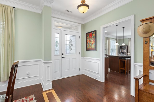 215 Dungarven Loop, Cary, NC 27513 - foyer featuring wainscoting, ornamental molding, dark wood-type flooring, and a decorative wall