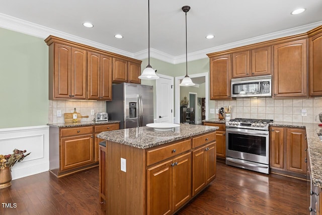 215 Dungarven Loop, Cary, NC 27513 - kitchen featuring appliances with stainless steel finishes, dark wood-style flooring, a kitchen island, stone counters, and pendant lighting