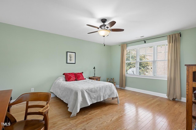215 Dungarven Loop, Cary, NC 27513 - bedroom with baseboards, light wood-style floors, and a ceiling fan