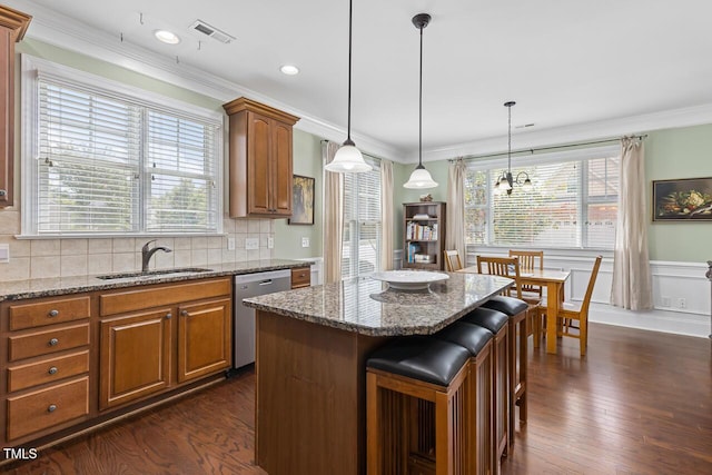 215 Dungarven Loop, Cary, NC 27513 - kitchen featuring a sink, stainless steel dishwasher, healthy amount of natural light, dark wood finished floors, and crown molding