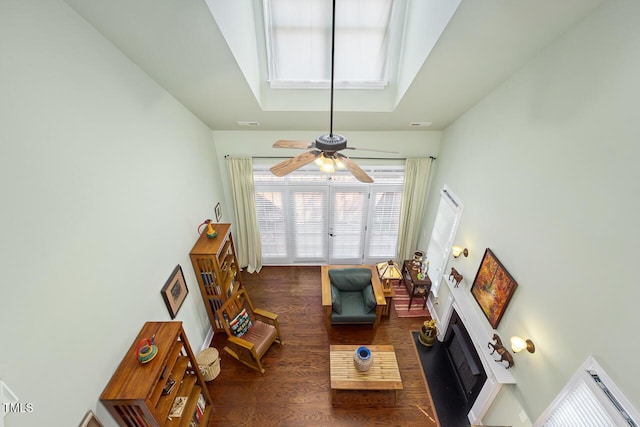 215 Dungarven Loop, Cary, NC 27513 - living area featuring wood finished floors, ceiling fan, a skylight, and a fireplace