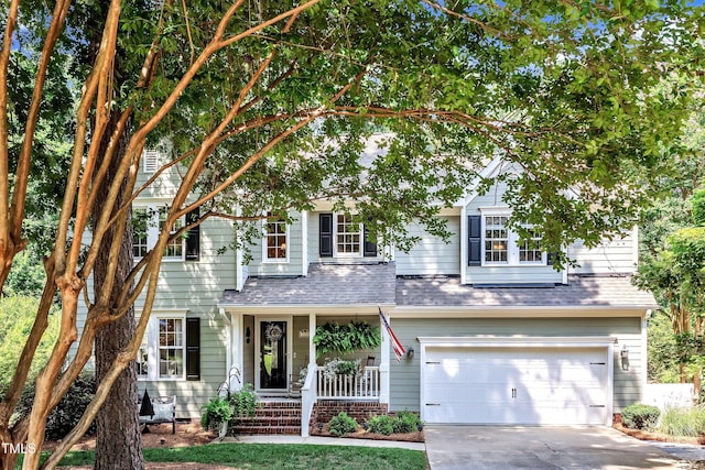 115 E Seve Ct, Morrisville, NC 27560 - view of front of home featuring an attached garage, covered porch, driveway, and roof with shingles