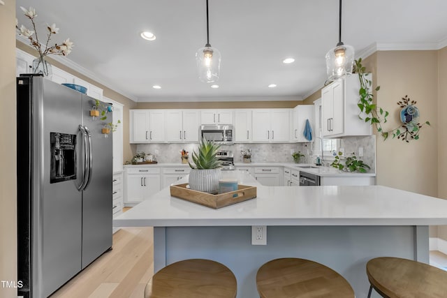 115 E Seve Ct, Morrisville, NC 27560 - kitchen featuring appliances with stainless steel finishes, a breakfast bar, light countertops, white cabinets, and light wood-type flooring