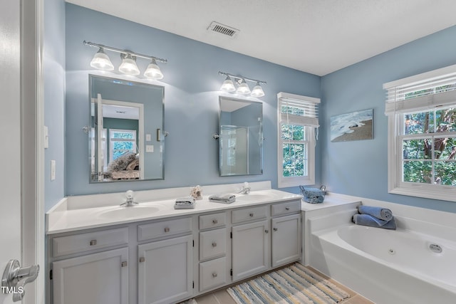 115 E Seve Ct, Morrisville, NC 27560 - bathroom featuring a whirlpool tub, double vanity, and a shower