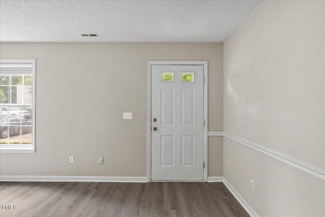 2228 Walnut Ridge Ct, Raleigh, NC 27610 - foyer entrance featuring wood finished floors, a textured ceiling, and baseboards