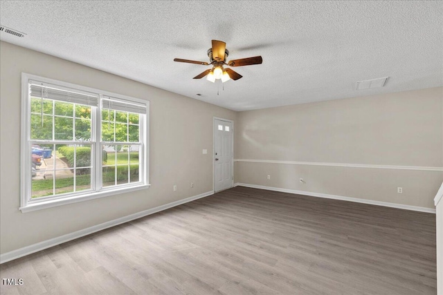 2228 Walnut Ridge Ct, Raleigh, NC 27610 - empty room with wood finished floors, ceiling fan, a textured ceiling, and baseboards