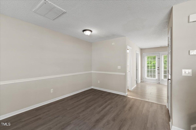 2228 Walnut Ridge Ct, Raleigh, NC 27610 - unfurnished room with wood finished floors, baseboards, and a textured ceiling