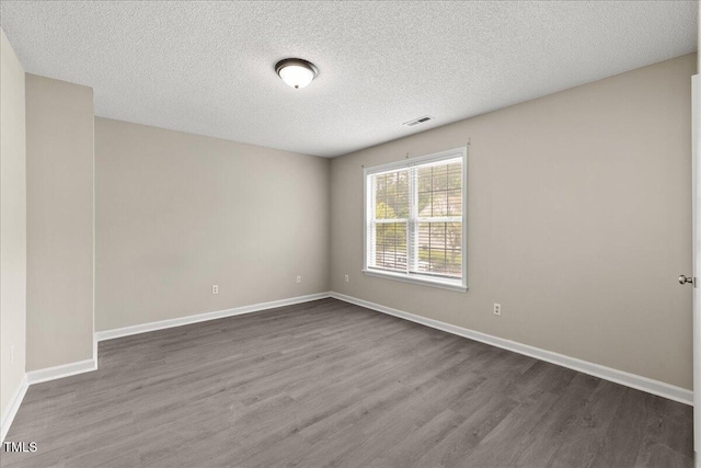 2228 Walnut Ridge Ct, Raleigh, NC 27610 - unfurnished room with dark wood-style floors, baseboards, and a textured ceiling