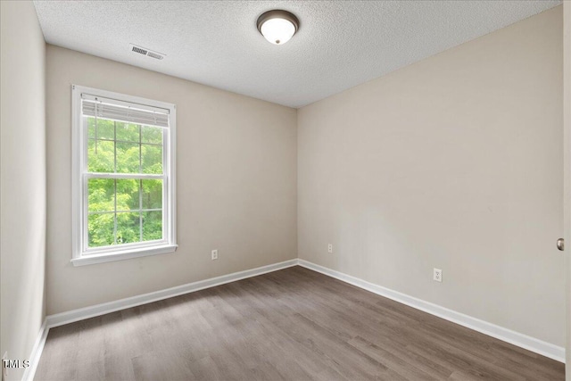 2228 Walnut Ridge Ct, Raleigh, NC 27610 - spare room featuring wood finished floors, a textured ceiling, and baseboards