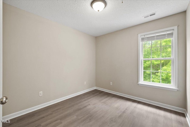2228 Walnut Ridge Ct, Raleigh, NC 27610 - unfurnished room with wood finished floors, baseboards, and a textured ceiling