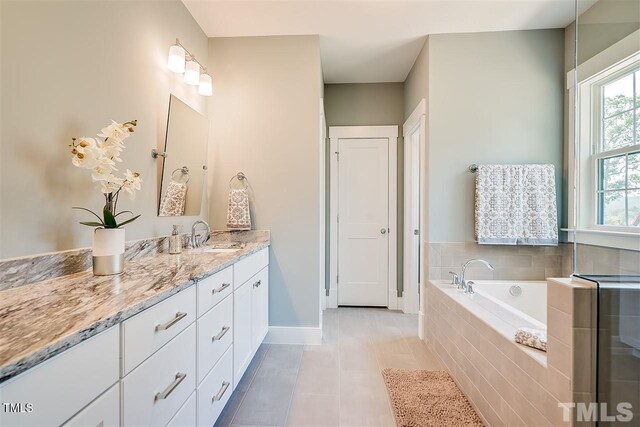 105 Everam Ct, Chapel Hill, NC 27516 - bathroom with vanity, a bath, baseboards, and tile patterned flooring