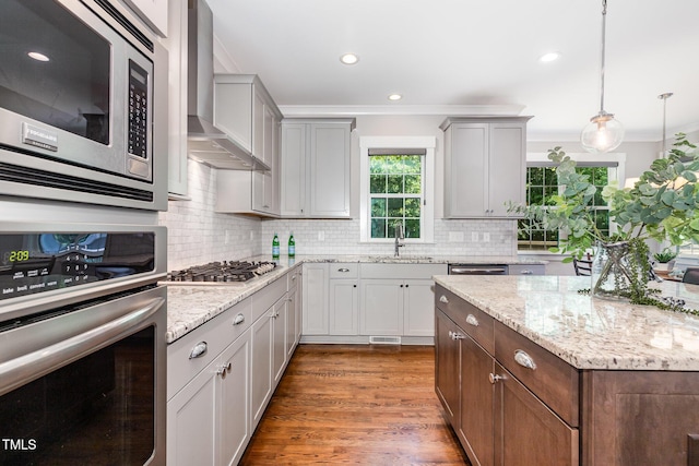 105 Everam Ct, Chapel Hill, NC 27516 - kitchen featuring stainless steel appliances, wall chimney range hood, ornamental molding, a sink, and tasteful backsplash