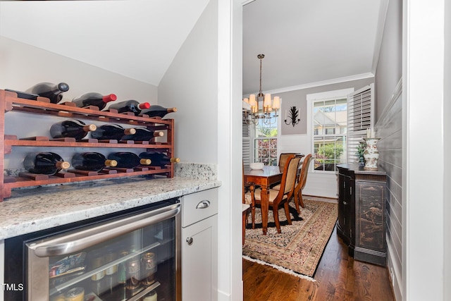 105 Everam Ct, Chapel Hill, NC 27516 - bar with wine cooler, dark wood finished floors, a chandelier, crown molding, and hanging light fixtures