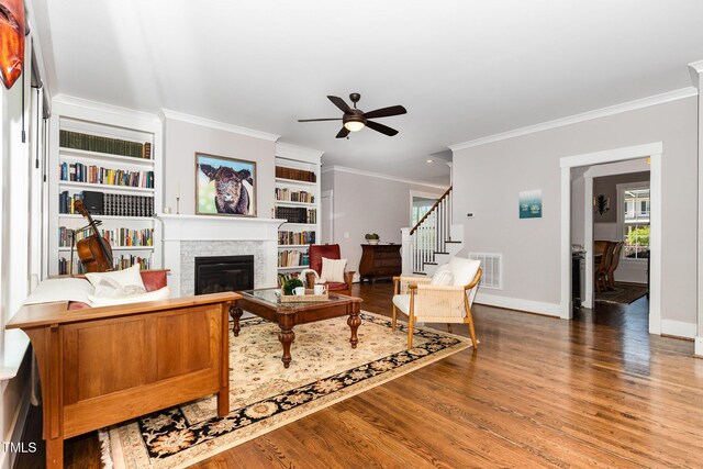 105 Everam Ct, Chapel Hill, NC 27516 - living room featuring a glass covered fireplace, ornamental molding, wood finished floors, ceiling fan, and stairs