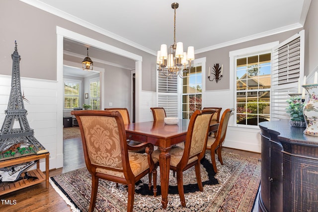 105 Everam Ct, Chapel Hill, NC 27516 - dining room with healthy amount of natural light, a chandelier, wood finished floors, a wainscoted wall, and crown molding