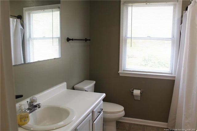 1955 Fairforest Dr, Fayetteville, NC 28304 - full bathroom with toilet, vanity, baseboards, and a shower with shower curtain