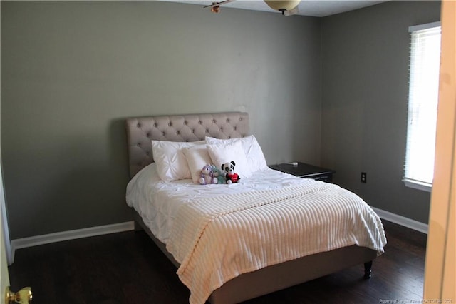 1955 Fairforest Dr, Fayetteville, NC 28304 - bedroom featuring multiple windows, wood finished floors, and baseboards