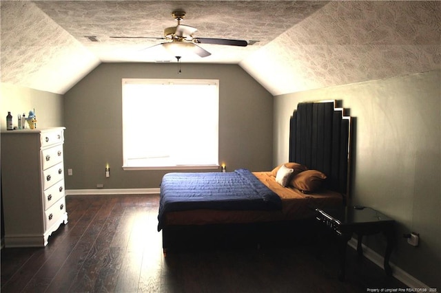 1955 Fairforest Dr, Fayetteville, NC 28304 - bedroom featuring vaulted ceiling, dark wood-style floors, baseboards, a textured ceiling, and a ceiling fan