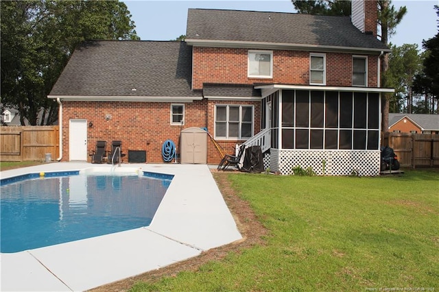 1955 Fairforest Dr, Fayetteville, NC 28304 - back of property with a sunroom, brick siding, a chimney, a patio area, and roof with shingles