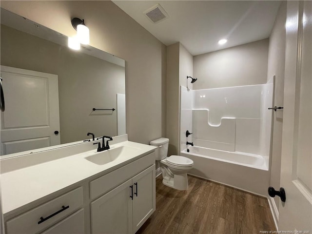 220 Gallery Dr Unit 201, Spring Lake, NC 28390 - bathroom featuring wood finished floors, toilet, vanity, and shower / bathtub combination