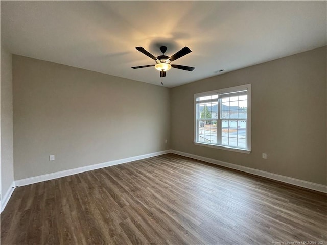 220 Gallery Dr Unit 201, Spring Lake, NC 28390 - unfurnished room featuring dark wood-type flooring, baseboards, and a ceiling fan