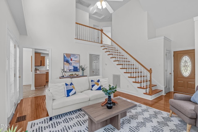 2575 Primrose Ln, Creedmoor, NC 27522 - living area with a towering ceiling, stairs, light wood finished floors, and a ceiling fan