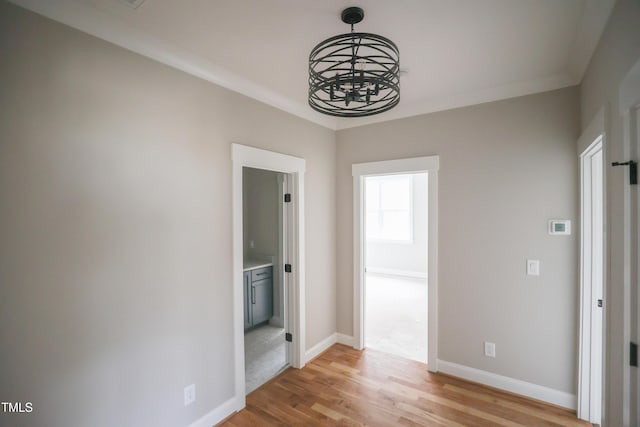 913 Harrison Ridge Rd, Wake Forest, NC 27587 - unfurnished room with light wood-type flooring, a chandelier, and baseboards