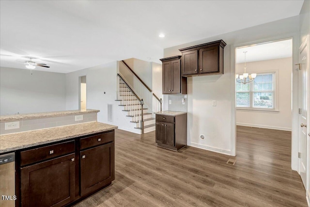131 Hawick Ct, Zebulon, NC 27597 - kitchen with dark brown cabinets, stainless steel dishwasher, dark wood finished floors, a chandelier, and a ceiling fan