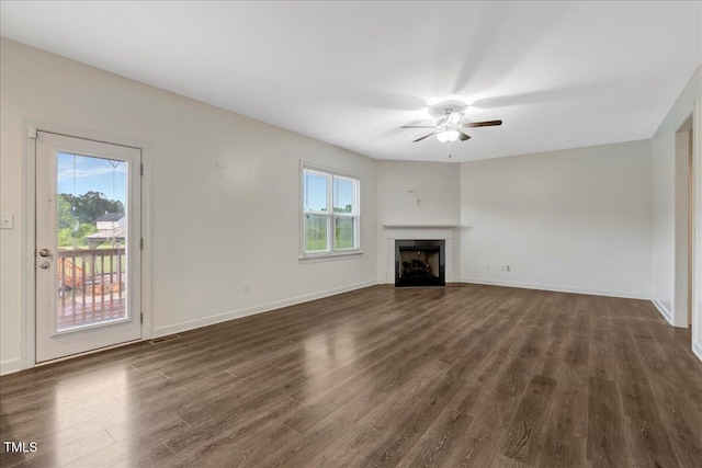 131 Hawick Ct, Zebulon, NC 27597 - unfurnished living room with ceiling fan, plenty of natural light, dark wood-style flooring, and a fireplace