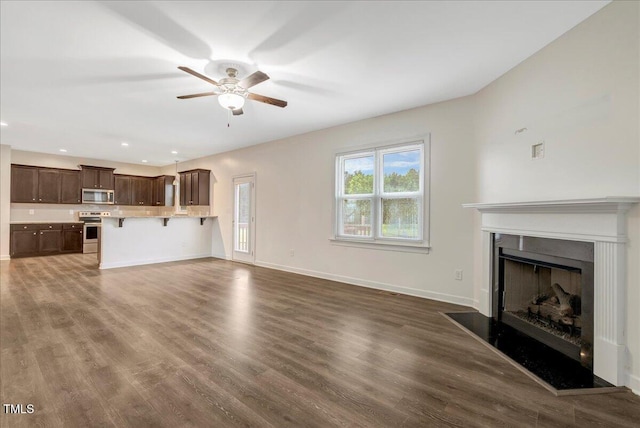 131 Hawick Ct, Zebulon, NC 27597 - unfurnished living room with a ceiling fan, dark wood-style floors, a fireplace, and recessed lighting