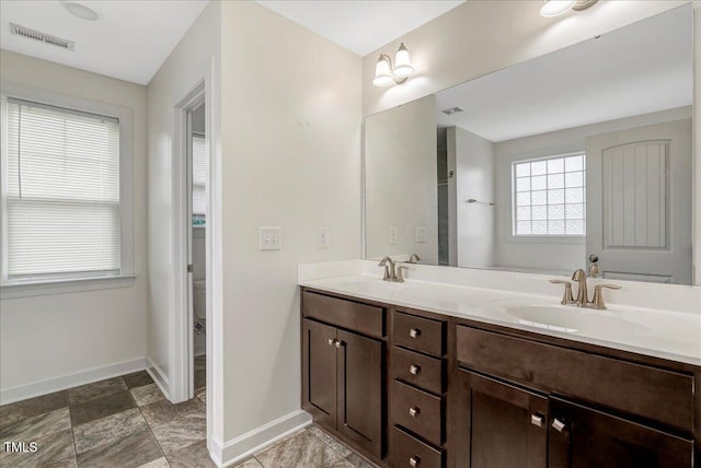 131 Hawick Ct, Zebulon, NC 27597 - bathroom featuring baseboards and double vanity