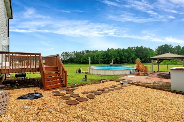 131 Hawick Ct, Zebulon, NC 27597 - view of grassy yard featuring a gazebo, a wooden deck, an outdoor pool, and stairway