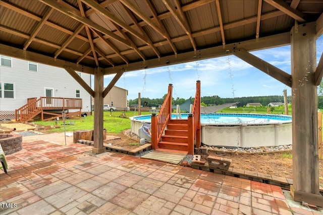 131 Hawick Ct, Zebulon, NC 27597 - view of patio / terrace with an outdoor pool, a deck, a fire pit, and stairs