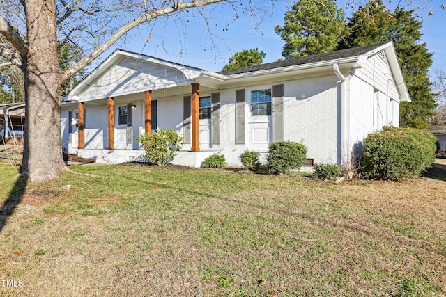 1246 NC-27, Benson, NC 27504 - view of front of home with a front lawn, brick siding, and covered porch
