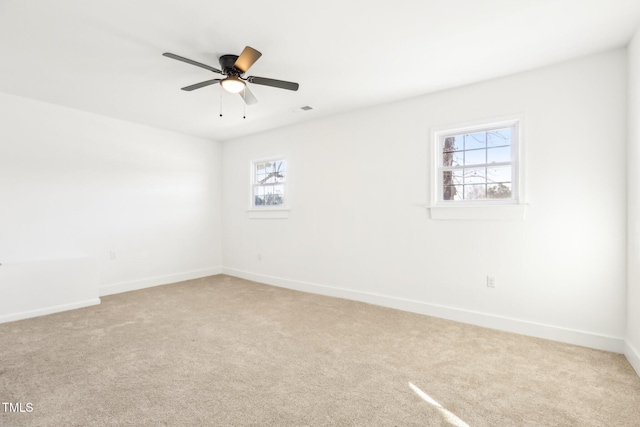 1246 NC-27, Benson, NC 27504 - spare room featuring light colored carpet, baseboards, and a ceiling fan