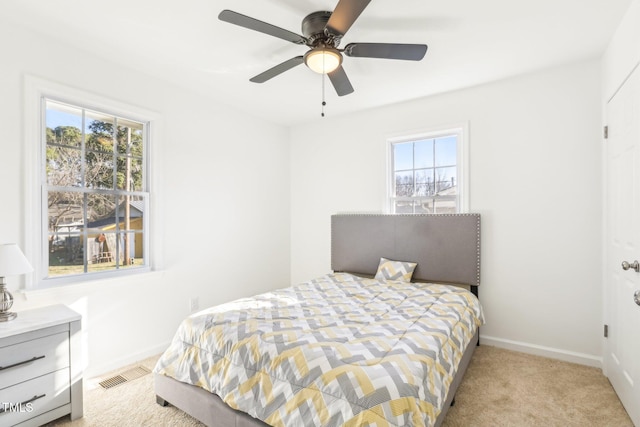 1246 NC-27, Benson, NC 27504 - bedroom featuring multiple windows, baseboards, light colored carpet, and a ceiling fan
