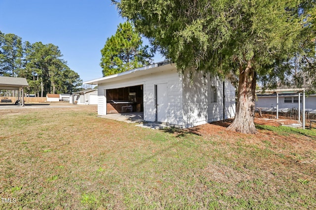 1246 NC-27, Benson, NC 27504 - view of home's exterior featuring a lawn, a garage, and an outdoor structure