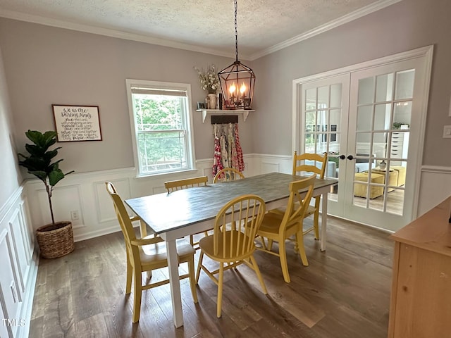 1003 Burnt Hickory Ct, Apex, NC 27502 - dining room featuring a chandelier, a textured ceiling, french doors, wood finished floors, and wainscoting