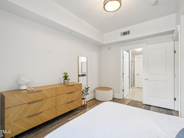 222 Glenwood Ave Unit 213, Raleigh, NC 27603 - bedroom featuring dark wood-style floors and connected bathroom