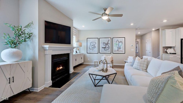 1124 Sun Springs Rd, Wake Forest, NC 27587 - living room featuring wood finished floors, a ceiling fan, a lit fireplace, baseboards, and recessed lighting